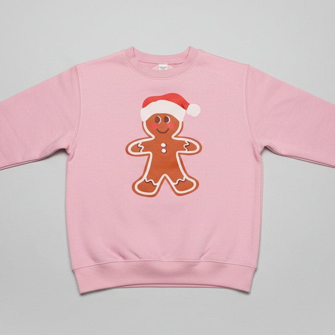 Pink sweatshirt with a gingerbread man design on a gray background