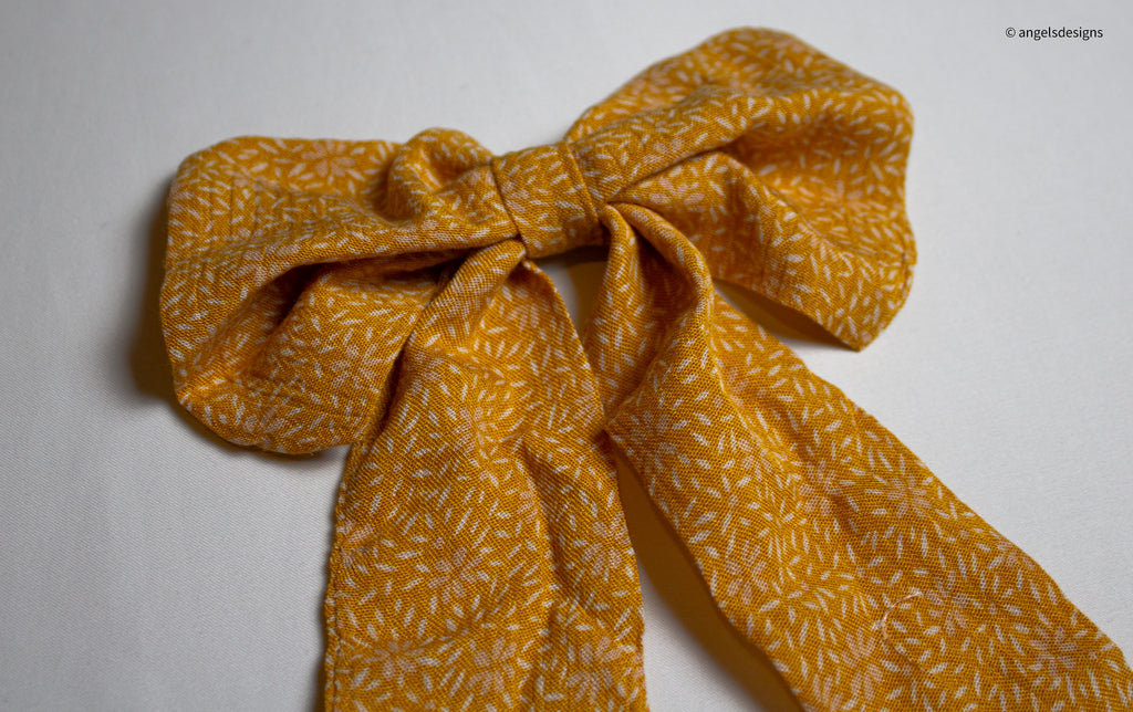 Little Girl's tangerine orange hair bows with tails