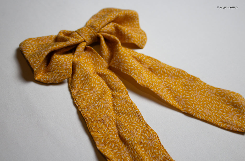 Little Girl's tangerine orange hair bows with tails