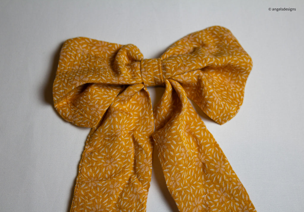 Little Girl's tangerine orange hair bows with tails