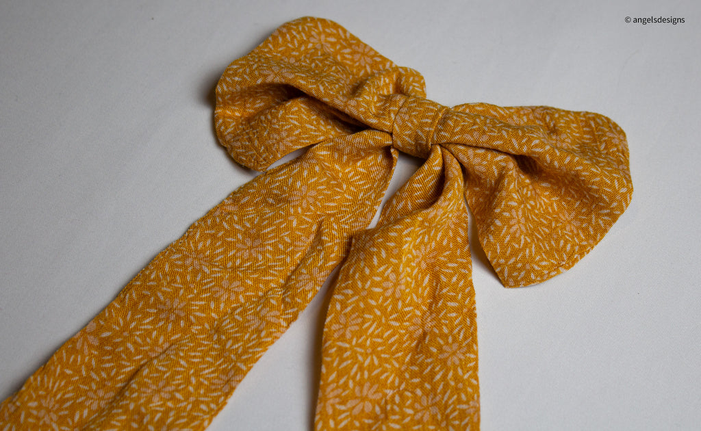Little Girl's tangerine orange hair bows with tails