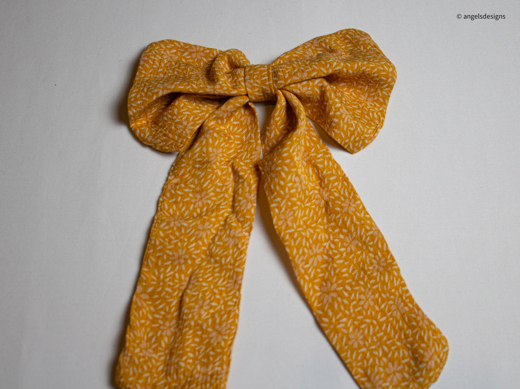 Little Girl's tangerine orange hair bows with tails