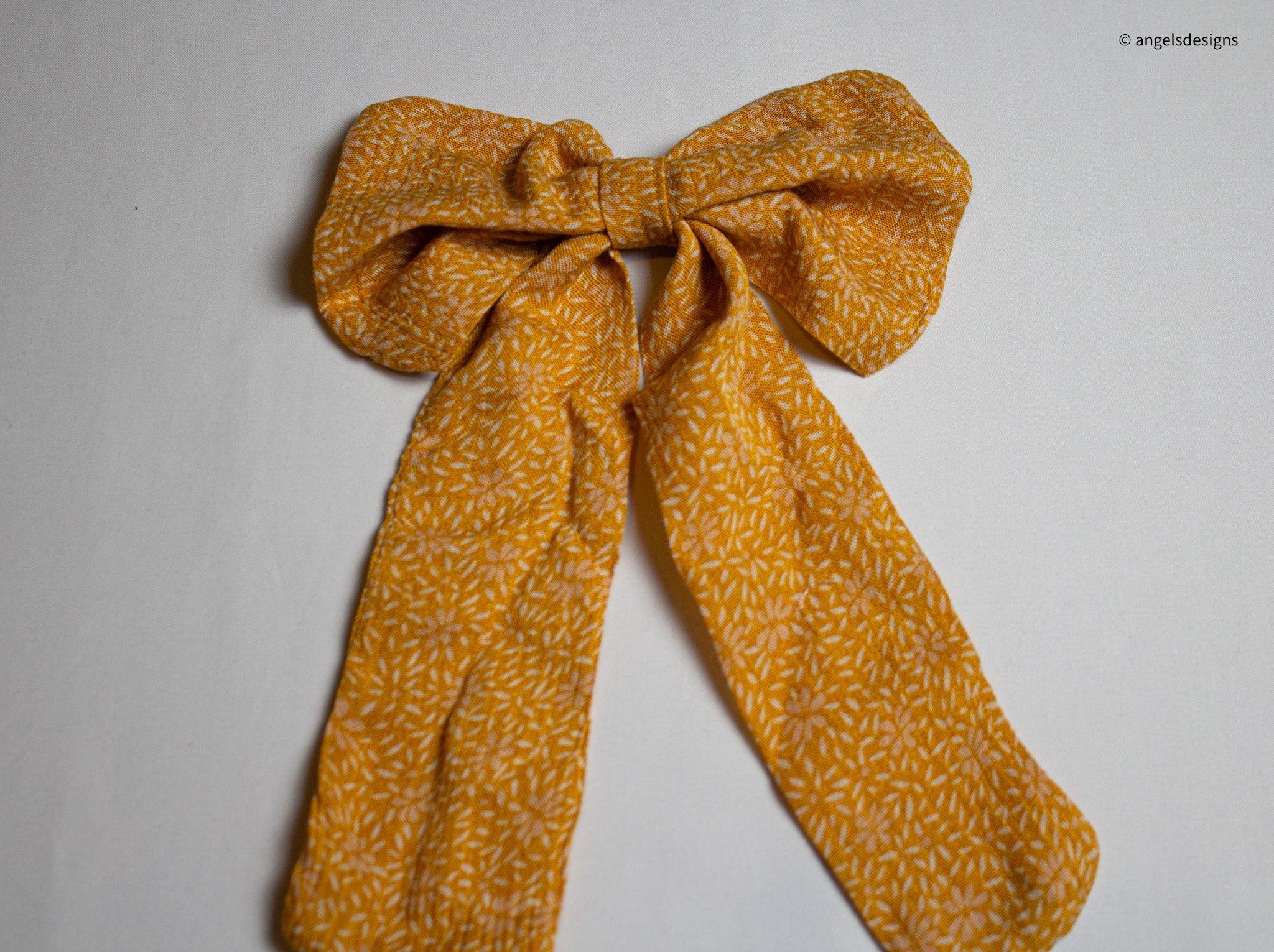 Little Girl's tangerine orange hair bows with tails