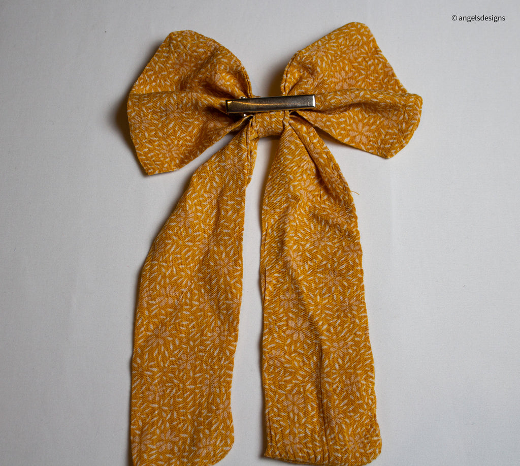 Little Girl's tangerine orange hair bows with tails