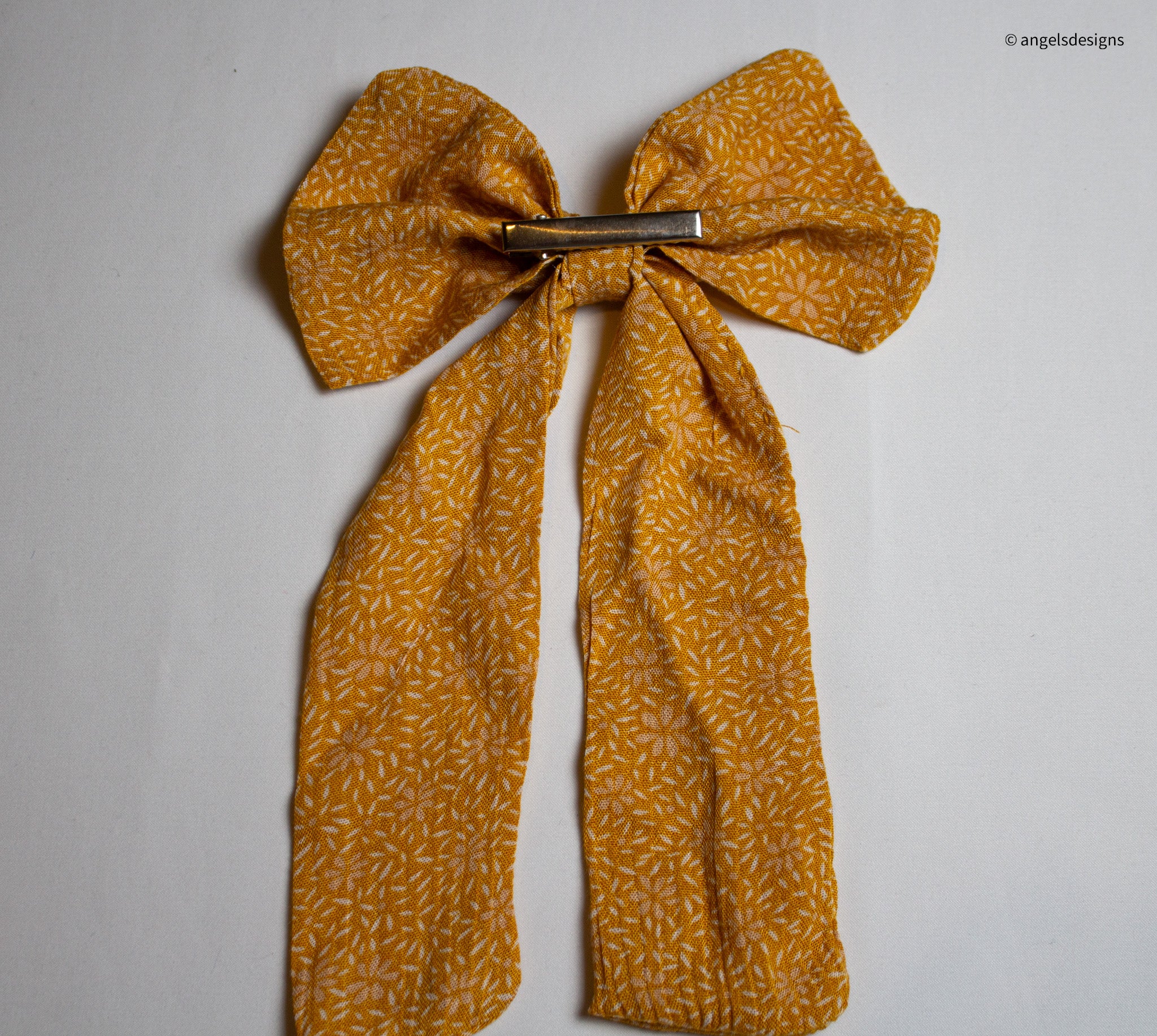 Little Girl's tangerine orange hair bows with tails