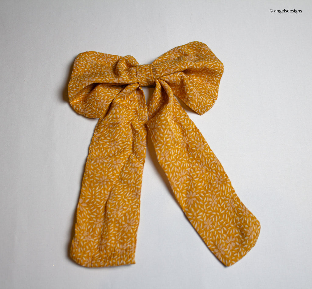 Little Girl's tangerine orange hair bows with tails