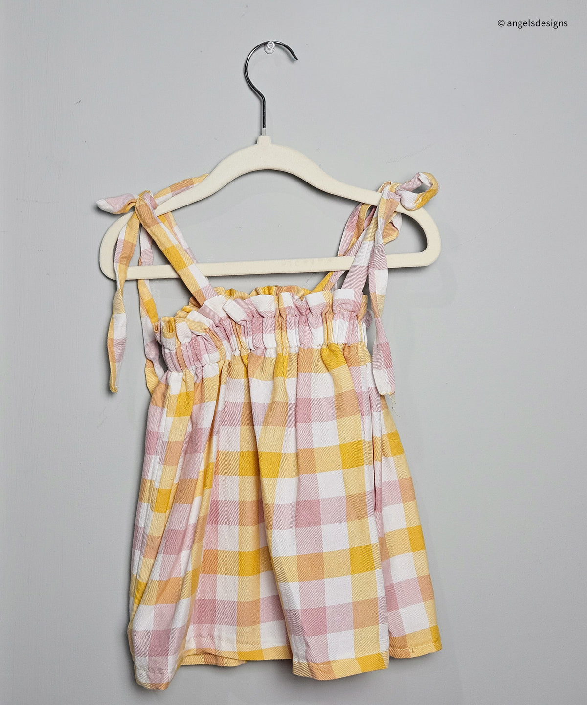 Girl's ruffled strap tie tank top